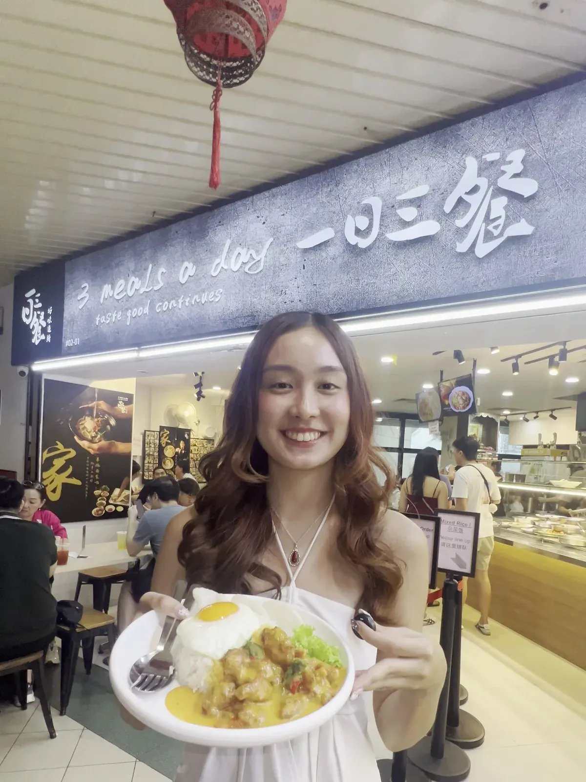 The signature plate served under the lit 3 Meals A Day stall signboard